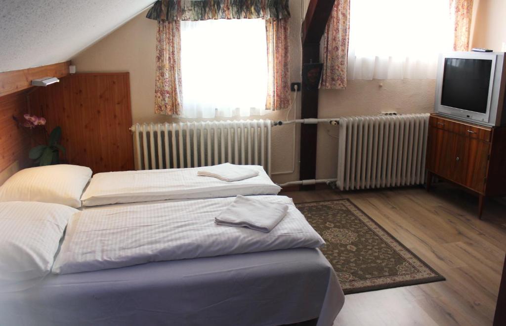 Postel nebo postele na pokoji v ubytování Erika Vendégház
