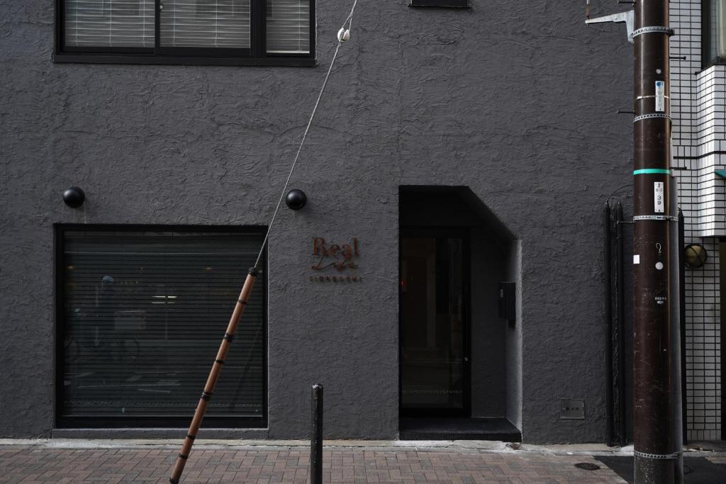 a ladder leaning against the side of a building at Real Life IIDABASHI in Tokyo