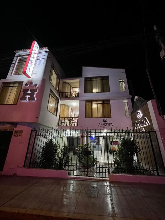 a building with a fence in front of it at night at HOTEL AREQUIPA in Nazca