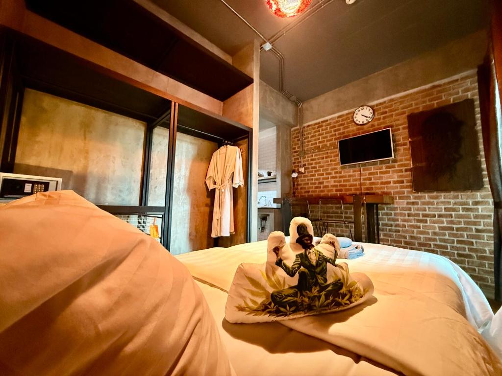 A playful bedroom view showing two adjacent beds, open storage and a wall-mounted TV.