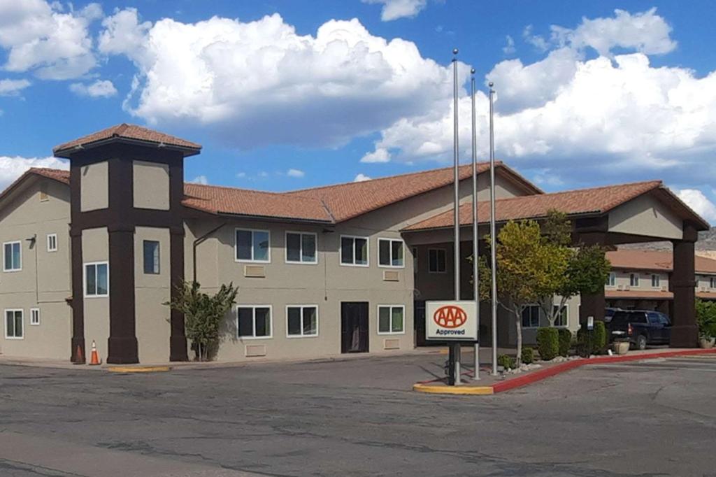 a large building with a sign in front of it at Quality Inn & Suites Grants - I-40 in Grants