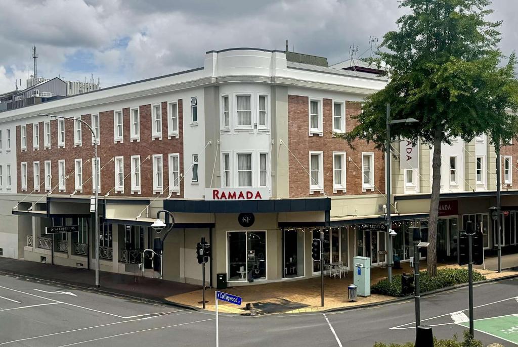 a building on the corner of a street at Ramada by Wyndham, Hamilton City Center in Hamilton