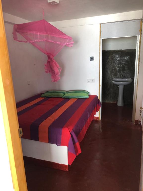 Postel nebo postele na pokoji v ubytování Ceylon Beach Home