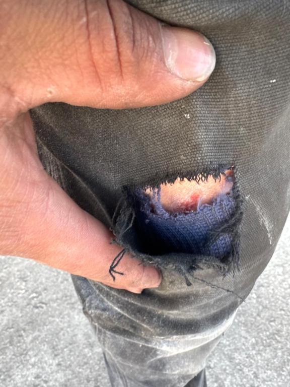 a hand with a tattoo on its thumb holding a piece of hair at Topacio in Taylorsville