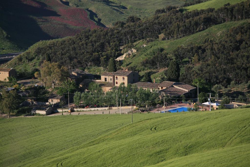 a large green field in front of a mountain at Agriturismo Monaco Di Mezzo in Resuttano