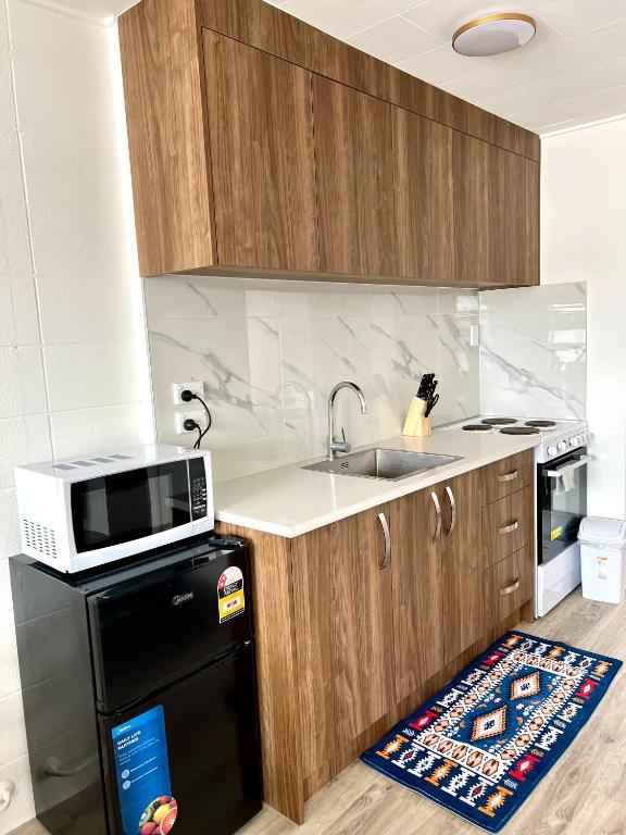 a kitchen with a sink and a microwave at Rotorua Stay in Rotorua