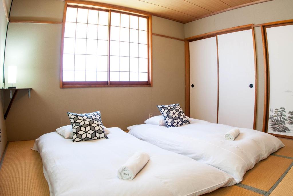 Postel nebo postele na pokoji v ubytování Kodama Lodge