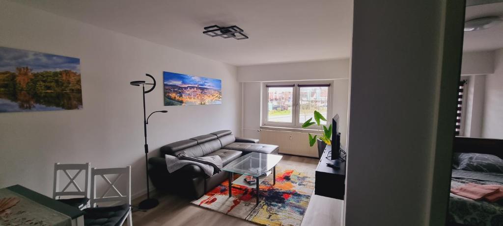 a living room with a couch and a table at Burgau Apartments Modern & Renovated in Jena