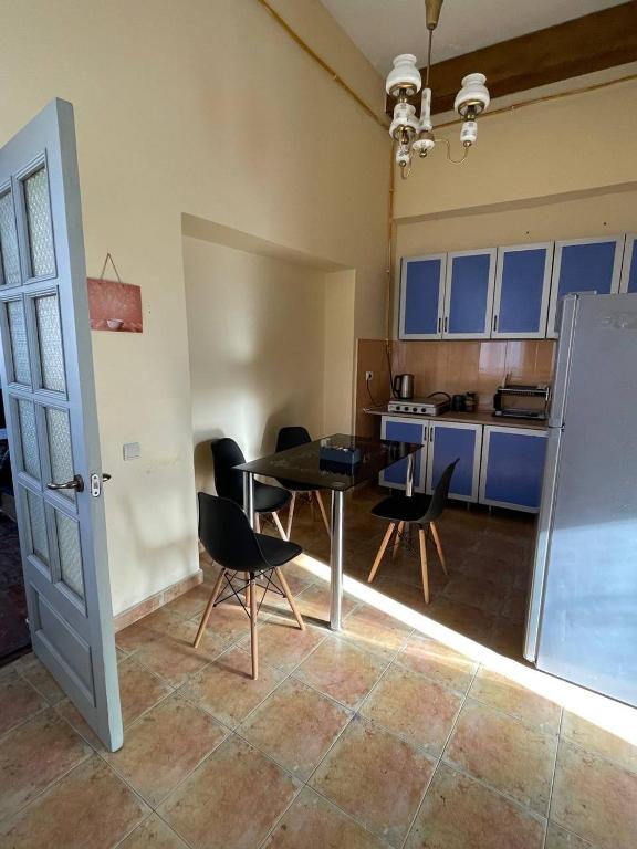 una cucina con tavolo e sedie in una stanza di Pick me HOSTEL a Batumi