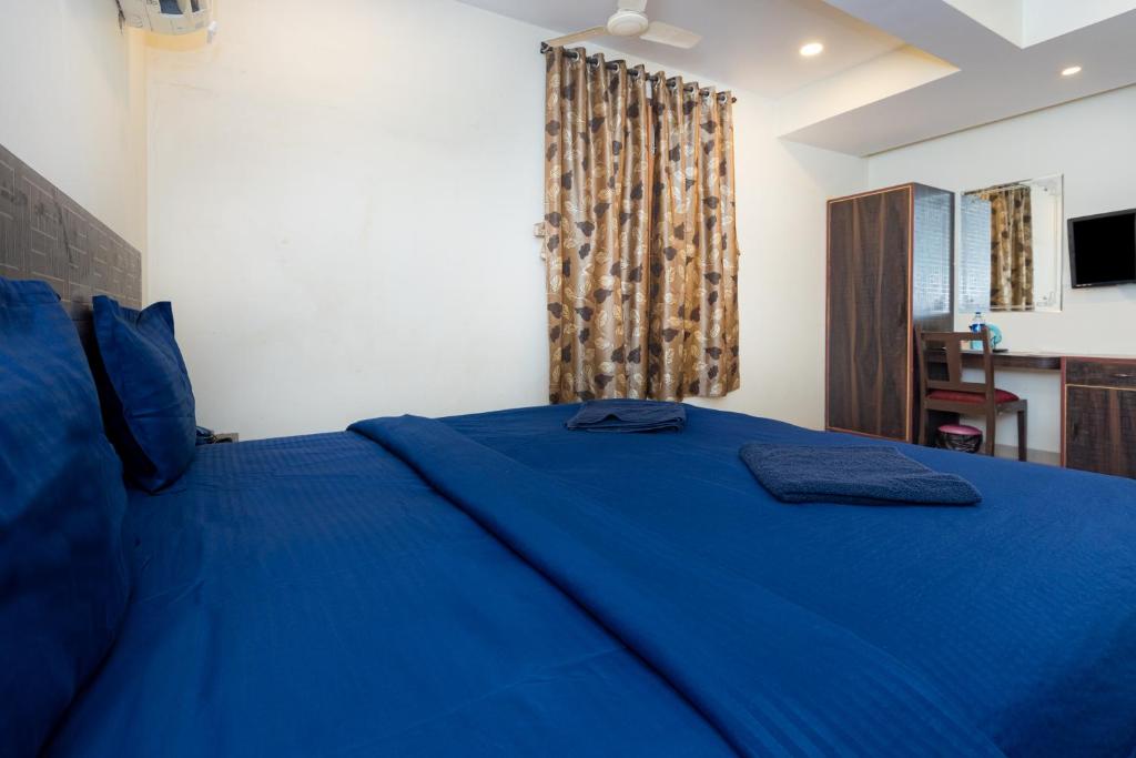 Postel nebo postele na pokoji v ubytování HOTEL AVISHA Residency