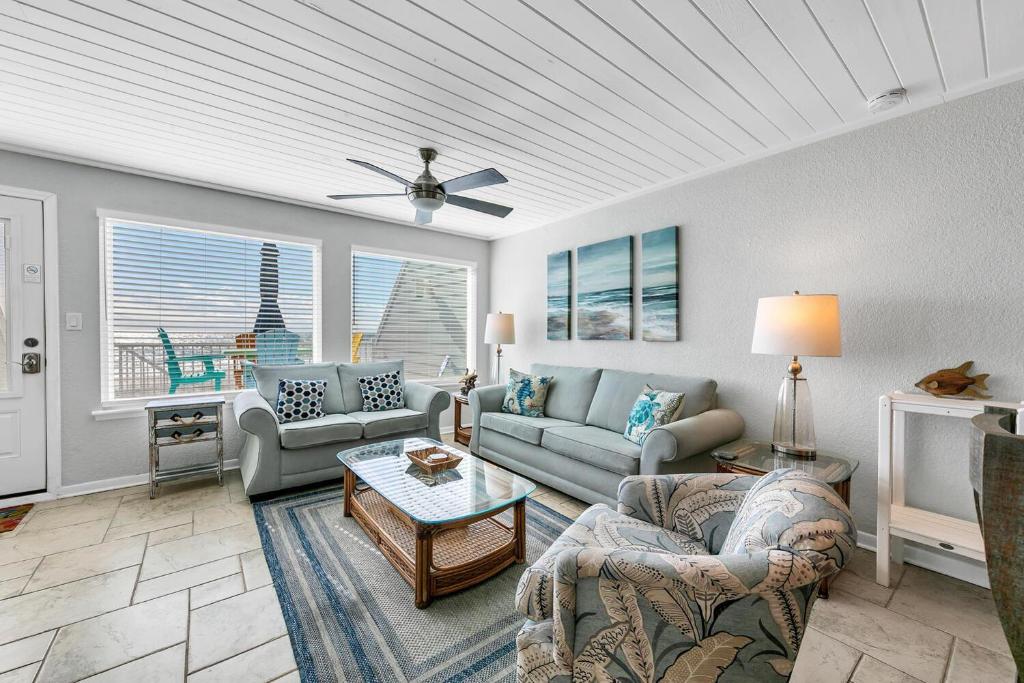 a living room with couches and a ceiling at The Shores Townhome #116 in Carillon Beach