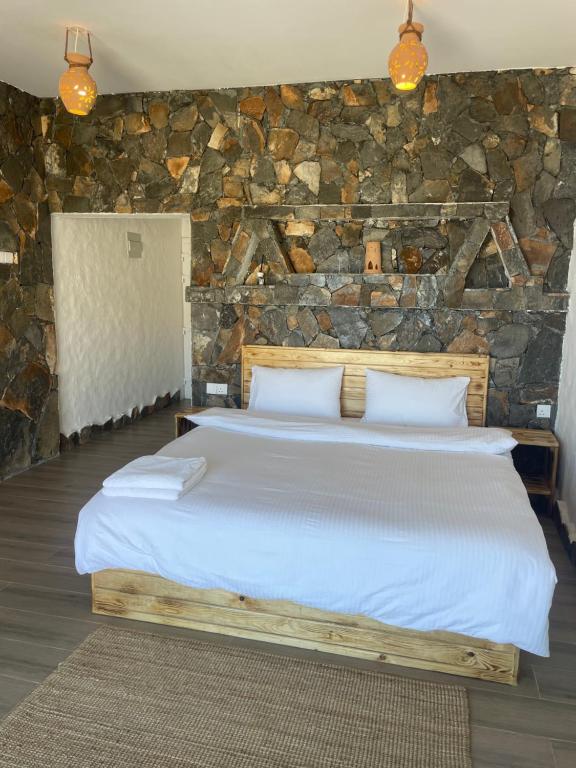 Postel nebo postele na pokoji v ubytování Panorama Guest House Jabal Shams