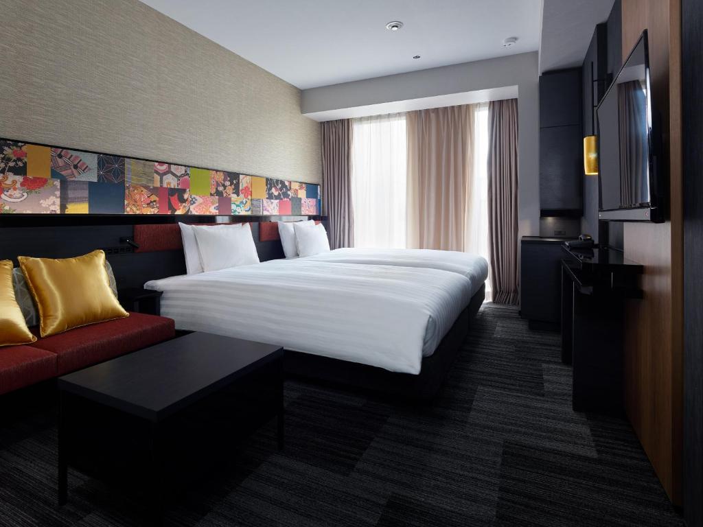 Postel nebo postele na pokoji v ubytování Mitsui Garden Hotel Kanazawa