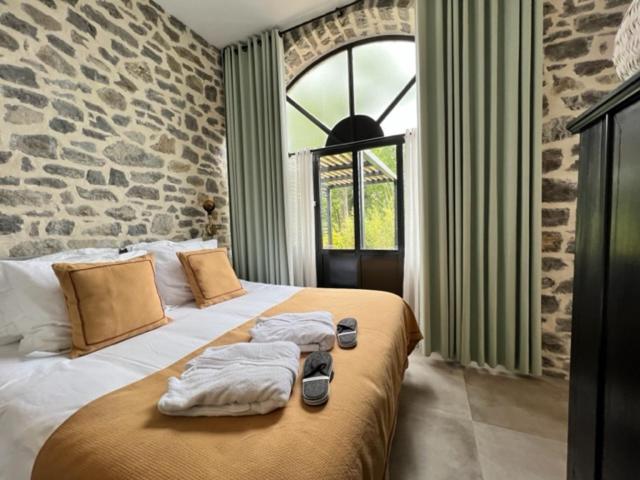 une chambre avec un lit avec des serviettes dessus dans l'établissement Studio apartment in the South Ardèche, à Saint-André-de-Cruzières