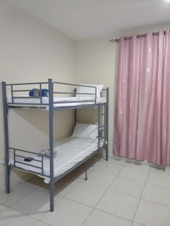 Postel nebo postele na pokoji v ubytování Muscat Galaxy Hostel