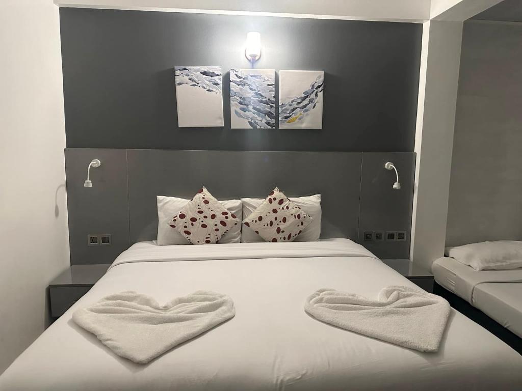 Postel nebo postele na pokoji v ubytování The G Ten Holiday Inn