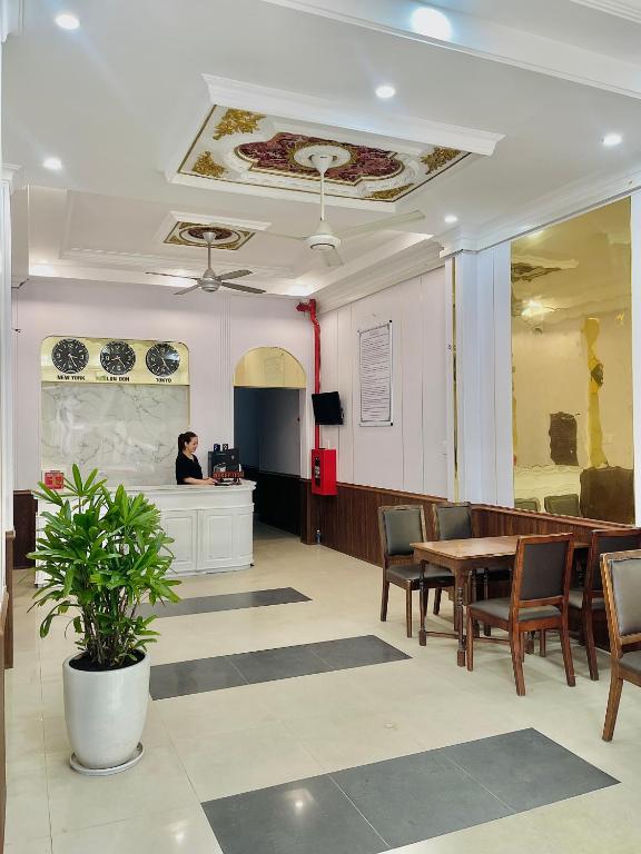 a woman sitting at a desk in a waiting room at Amy Hotel Hue in Hue
