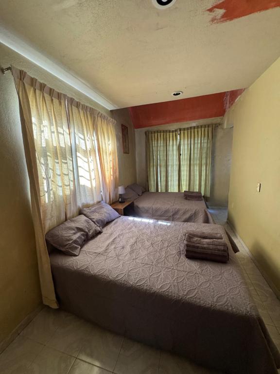 a bedroom with a large bed and a window at Un lugar muy bien ubicado in Morelia