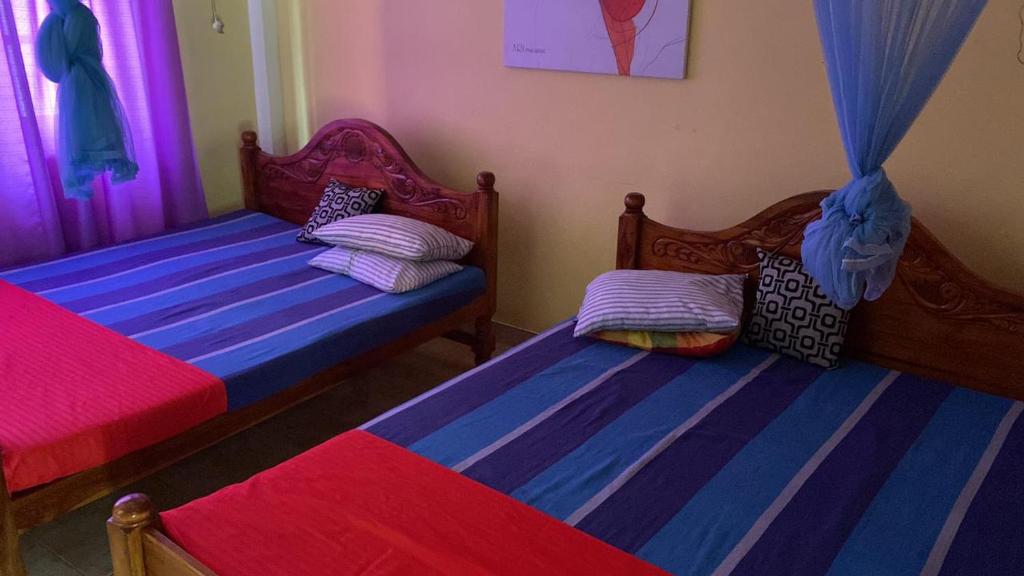 Postel nebo postele na pokoji v ubytování ARI Paradise