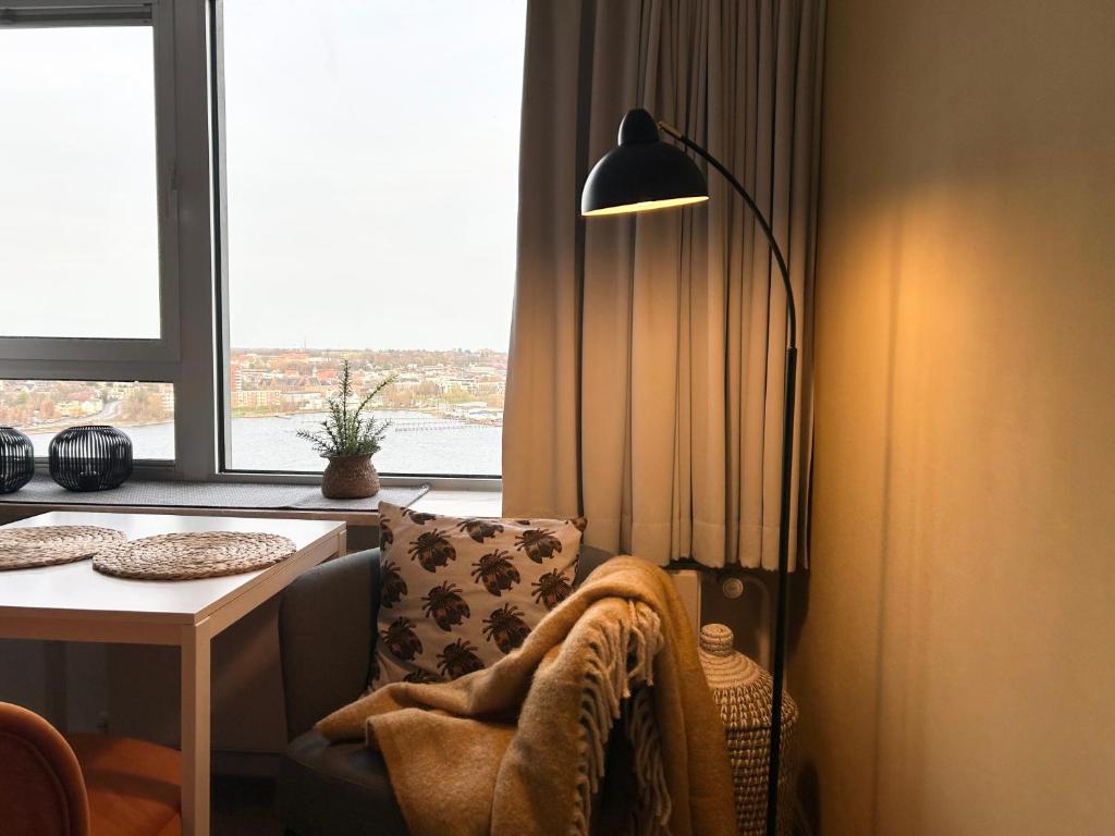 a living room with a chair and a table and a lamp at Schleiblick in Schleswig