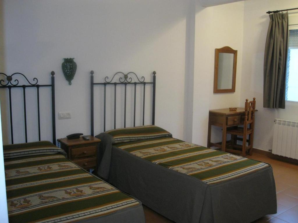 Postel nebo postele na pokoji v ubytování Hotel San Julian