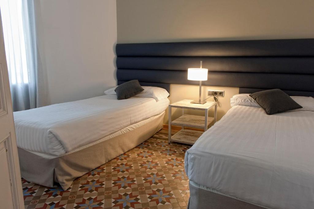 A bed or beds in a room at MH Apartments Tetuan