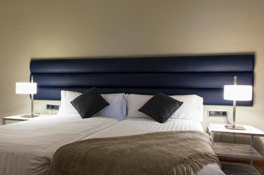 A bed or beds in a room at MH Apartments Tetuan