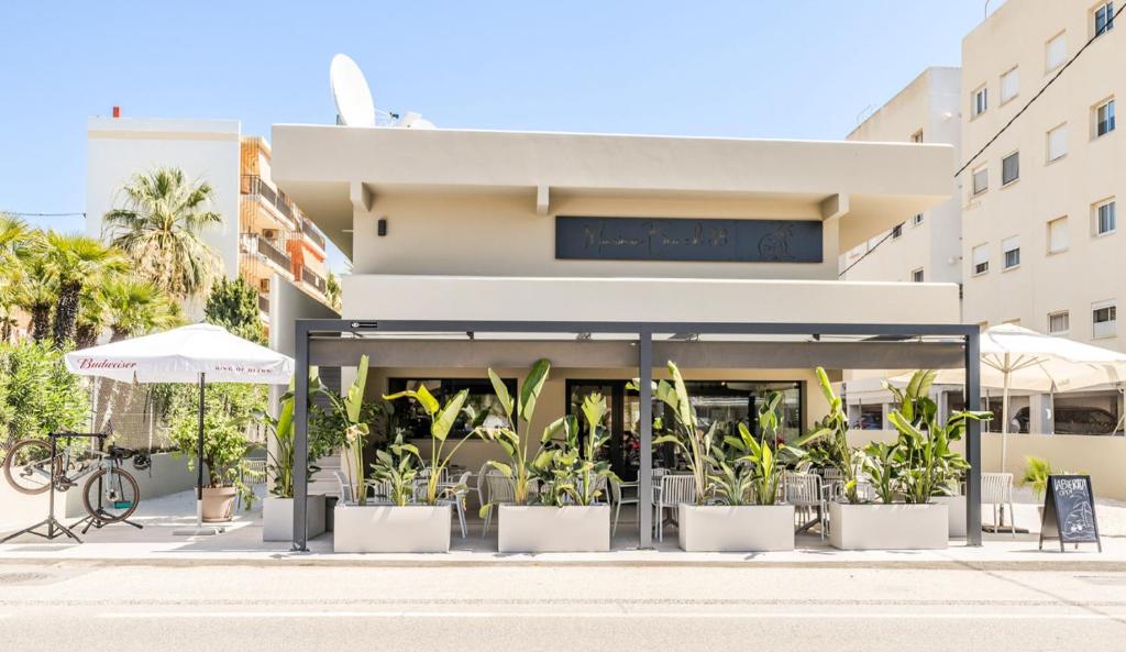 a restaurant with plants in front of a building at Marina Beach 38 Denia in Denia