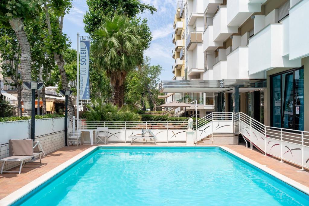 a swimming pool on the side of a building at Hotel Du Soleil in Rimini