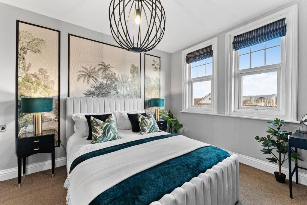 a white bedroom with a large bed and windows at The Artist Abode in The Bay - Hot-Tub - Pets in Robin Hood's Bay