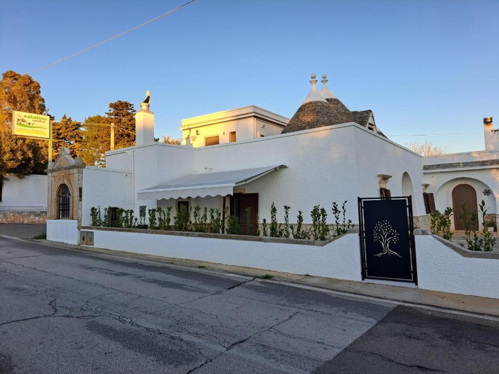 a white building on the side of a street at La Dimora di Peppe in Locorotondo