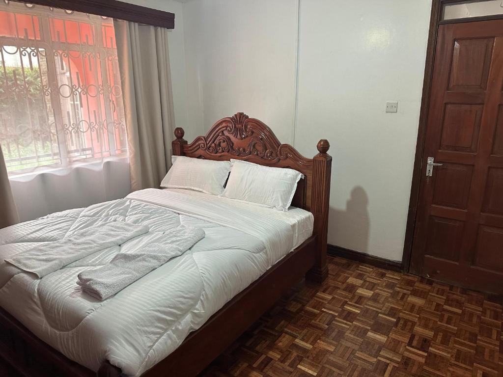 Postel nebo postele na pokoji v ubytování Milimani Guesthouse