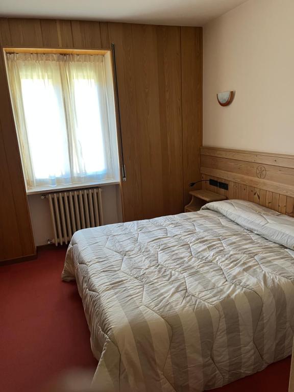 Postel nebo postele na pokoji v ubytování Albergo Piazzatorre