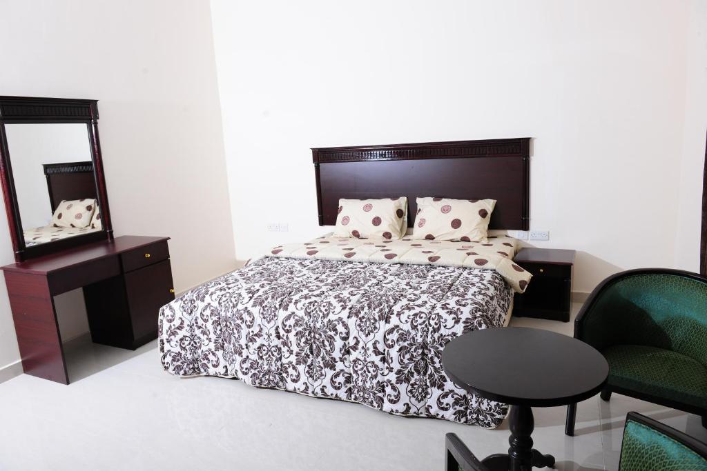 Postel nebo postele na pokoji v ubytování Al Jumhour Hotel Apartments