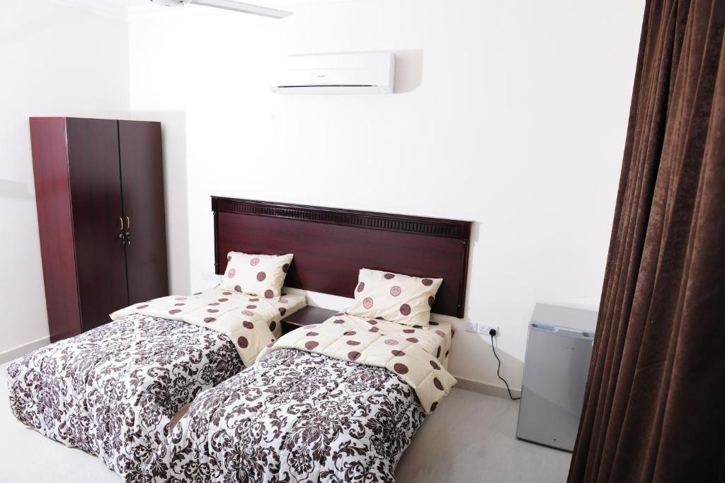 Postel nebo postele na pokoji v ubytování Al Jumhour Hotel Apartments