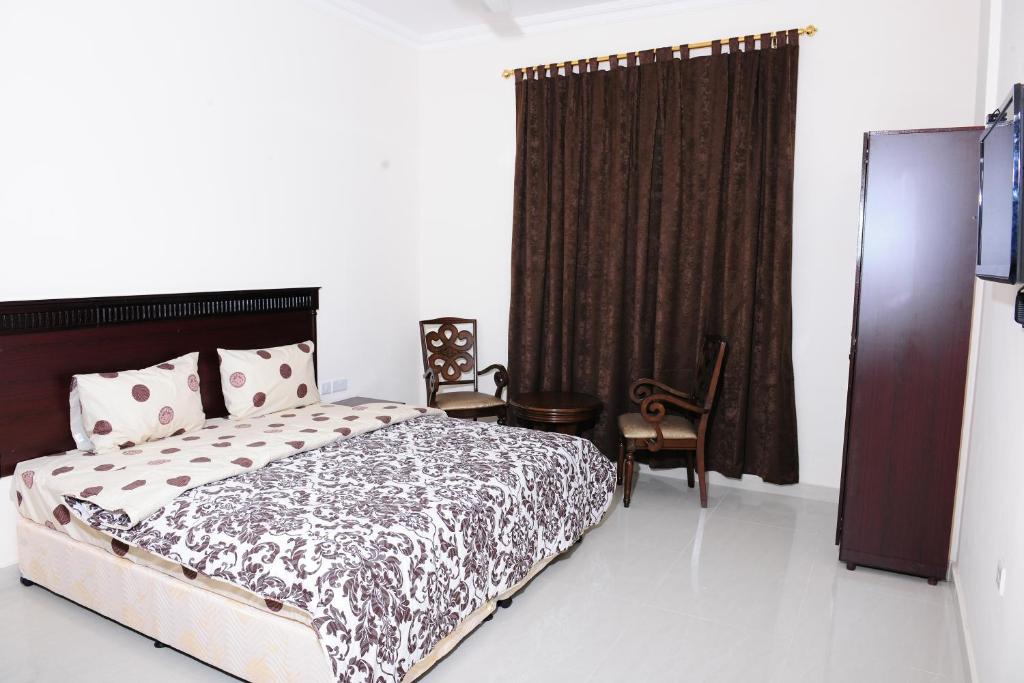 Postel nebo postele na pokoji v ubytování Al Jumhour Hotel Apartments