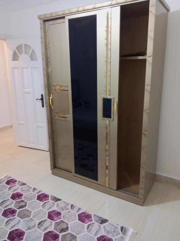 a dressing room with a glass door with a mirror at كامب شزار in Alexandria