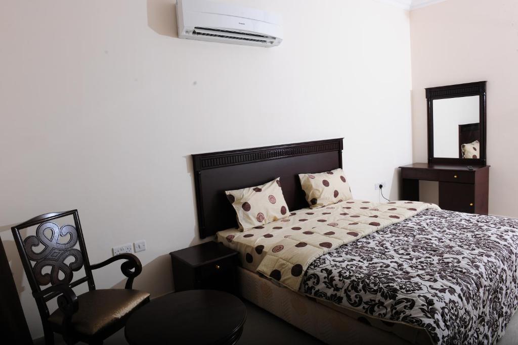 Postel nebo postele na pokoji v ubytování Al Jumhour Hotel Apartments