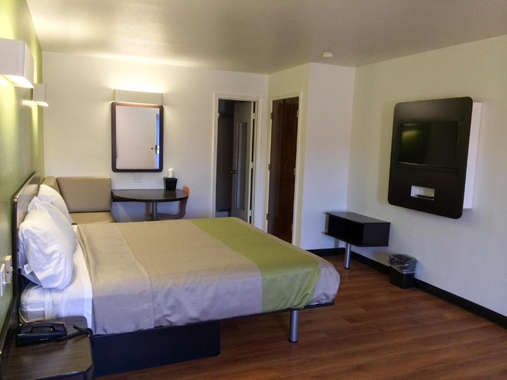 a hotel room with a bed and a tv at Motel 6-Longview, TX - North in Longview