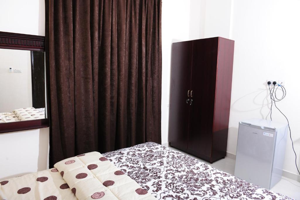 Postel nebo postele na pokoji v ubytování Al Jumhour Hotel Apartments