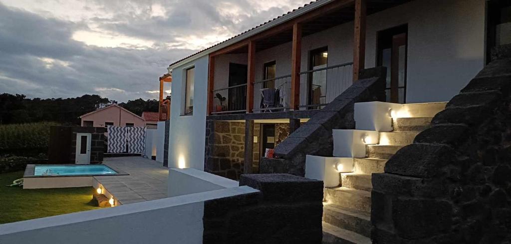 a house with a swimming pool and stairs with lights at Our Place in Pico in Companhia de Cima