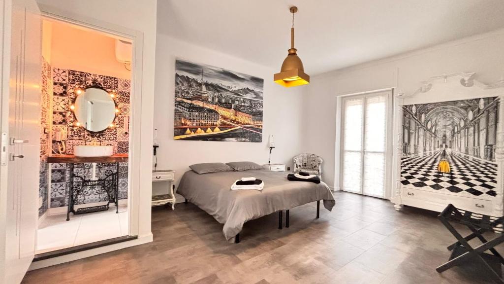 a bedroom with a bed and a large painting on the wall at Estilenuevo Fashion Rooms in Druento