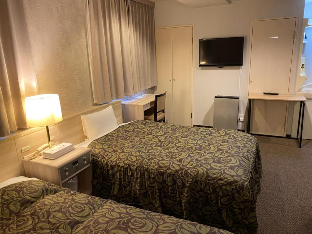 Postel nebo postele na pokoji v ubytování Hotel Sunrise21