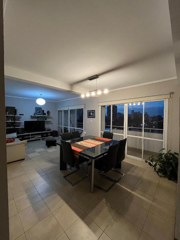 a living room with a dining room table and chairs at Altos Resistencia in Resistencia