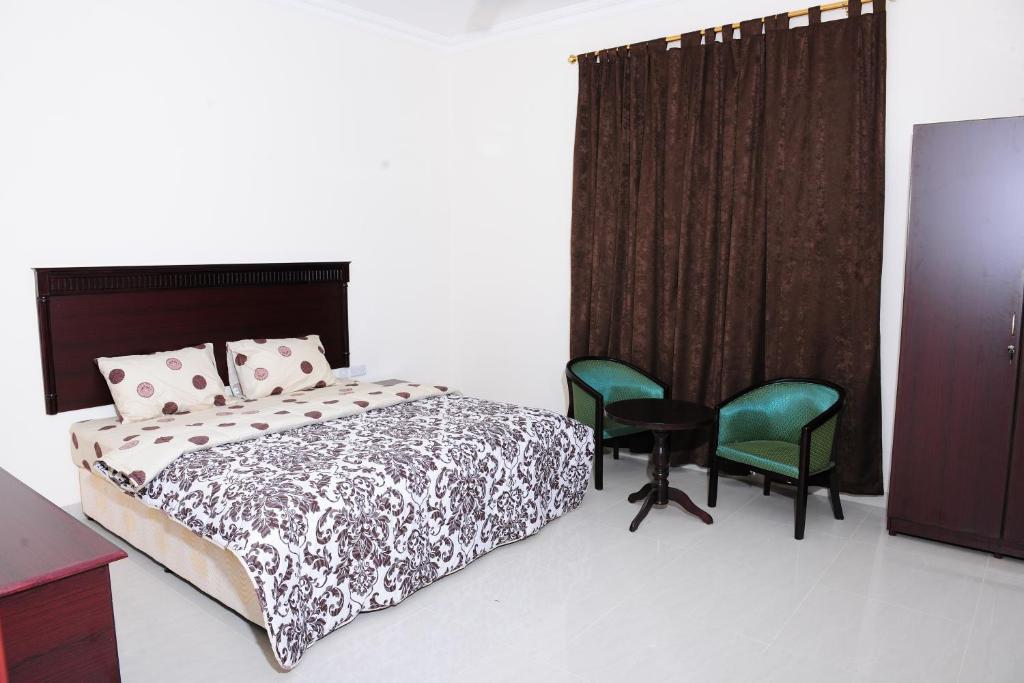 Postel nebo postele na pokoji v ubytování Al Jumhour Hotel Apartments