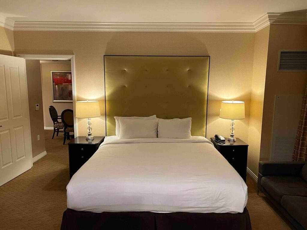 a large bed in a hotel room with two lamps at Mgm 1 Bedroom Balcony And Or Studio Luxury Suites in Las Vegas