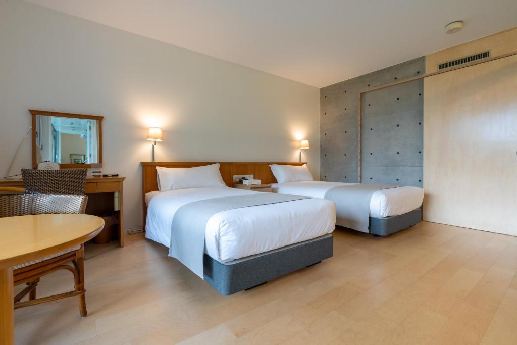 Postel nebo postele na pokoji v ubytování Karuizawa Tennku Hotel & Resort