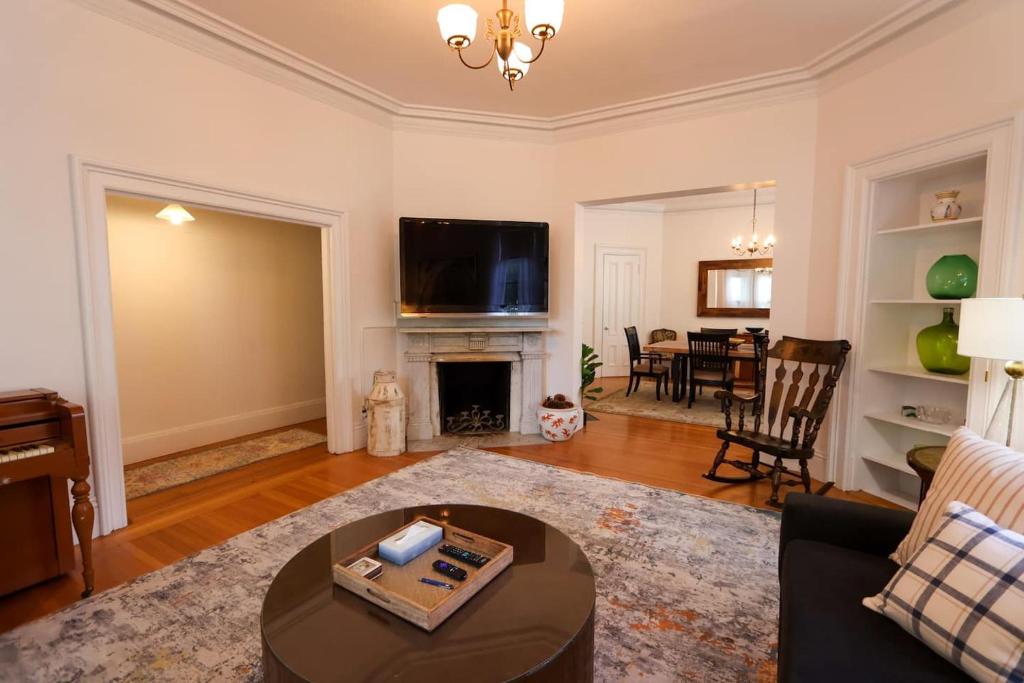 a living room with a couch and a fireplace at Over-sized 2levels, 3b-2ba, Victorian, Patio, Pkg in Brookline