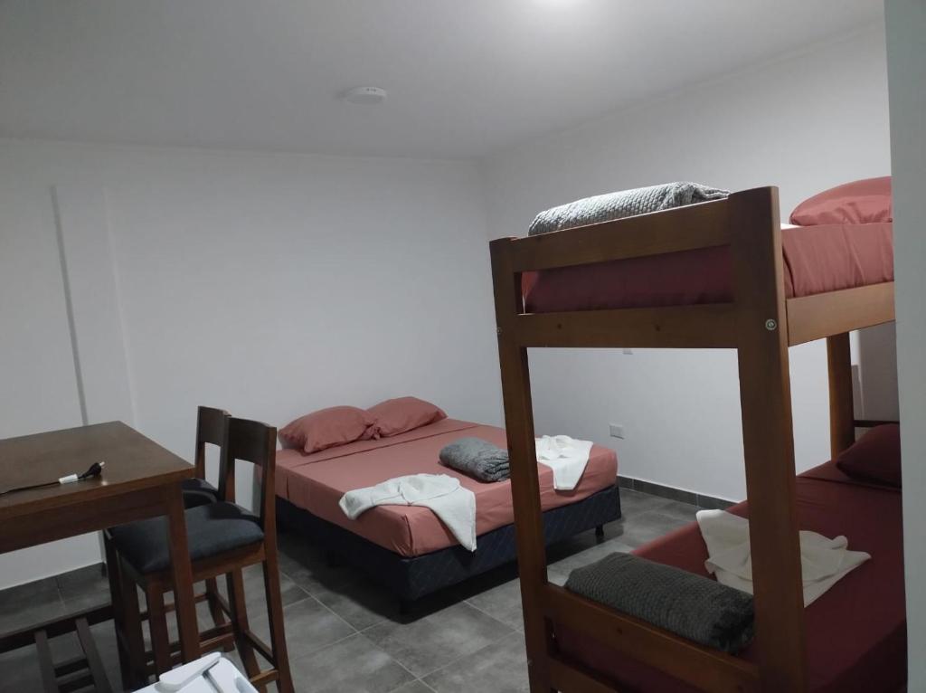 a room with two bunk beds and a table at Rincón del parana in Puerto Iguazú