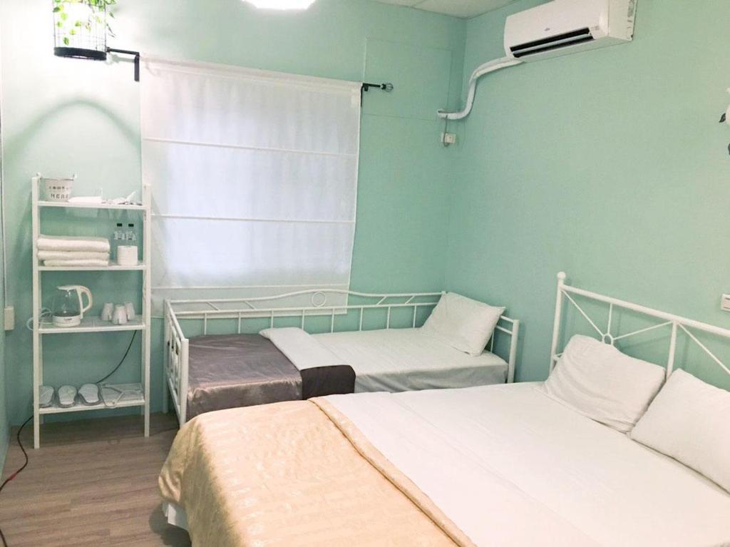 Postel nebo postele na pokoji v ubytování De Wang Villa